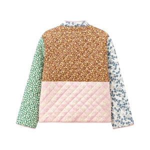 Detailed macro view of quilted floral patchwork jacket with diverse vintage patterns