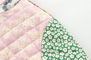 Detail of floral patchwork quilting with diamond stitching on a padded jacket