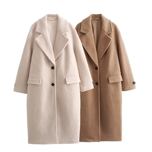 Close-up of wool coats with notched lapels and flap pockets in beige and camel colors