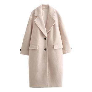 Close-up of beige wool coat featuring classic notched lapels and black button closure details
