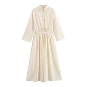 Detail of the elastic gathered waist and button closure on this cream midi shirt dress