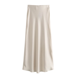Detail view of champagne satin maxi skirt showing silky texture and high-waisted A-line cut