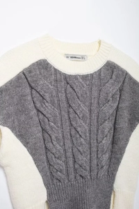 Close-up of contrast cable knit pattern and texture on a sleeveless sweater vest