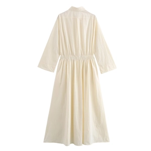Detailed close-up of the pleated elastic waist and buttoned collar on ivory midi dress