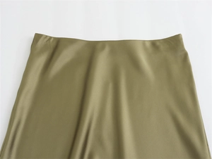 Detailed macro view of the smooth olive green satin texture and seamless high waistband design