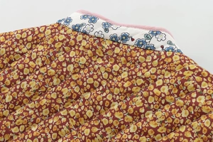 Detailed quilted texture of floral pattern cotton jacket with contrast stitching