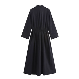 Detail view of the black shirt dress featuring an elasticated waist and pleated back design