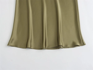 Detail of olive green satin skirt showing premium silky texture and hem stitching