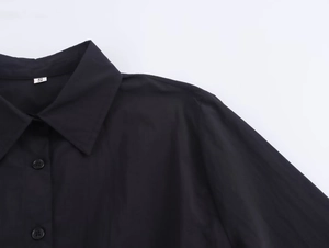 Close-up of black shirt midi dress collar with button details and size S label