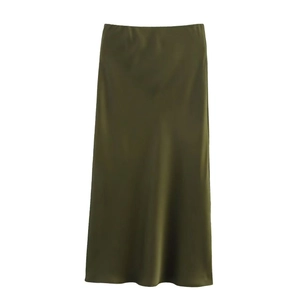 Detail of high-waist long satin skirt in dark olive green with silky smooth texture