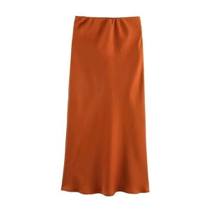 Detailed view of caramel satin high-waisted midi skirt with smooth glossy silk-like texture