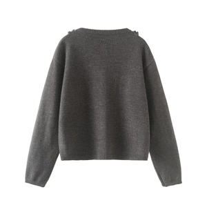 Detail of dark grey knit cardigan back view with fine needlework and ribbed texture hem