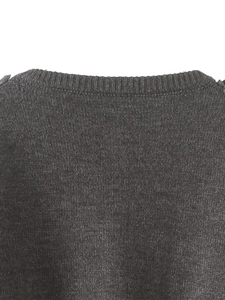 Detail showing the ribbed round neckline and dark grey knit texture of this cardigan