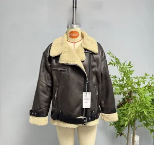 Detailed view of women's dark brown faux leather jacket with cream fleece collar and zippers