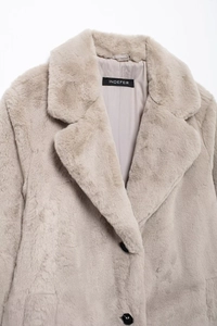 Close-up of light gray faux fur coat featuring wide lapels and a smooth inner lining