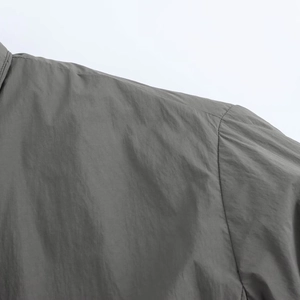 Close-up of gray street fashion kimono jacket showing fabric texture and shoulder seams