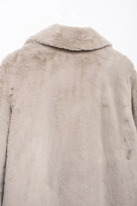 Detail shot of soft faux fur texture and collar structure of this beige winter coat