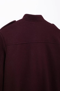 Macro shot of dark purple wool jacket back detail with stand collar and epaulettes