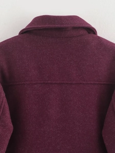 Detail view of the back yoke and high-quality wool blend fabric of the burgundy tweed jacket