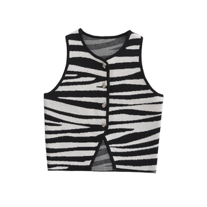 Detailed view of knitted zebra print vest with silver buttons and inverted V-hem design