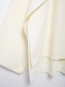Detailed macro view of the soft white knitted fabric texture and premium wool material