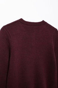 Detailed close-up of dark wine red knitted sweater collar and high-quality fabric texture