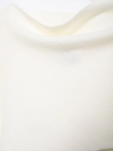 Close-up of premium white knitted wool fabric texture with soft fluffy cashmere finish