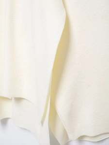 Close-up of the soft warm white knit fabric texture and premium wool-like fibers