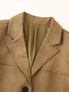 Detail shot of camel faux suede blazer featuring neat collar stitching and premium buttons