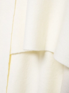 Close-up detail of soft white wool fabric with thick plush texture and luxury fiber finish