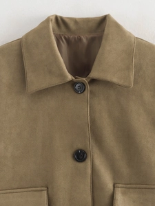 Detailed macro view of khaki suede jacket fabric texture with black round buttons