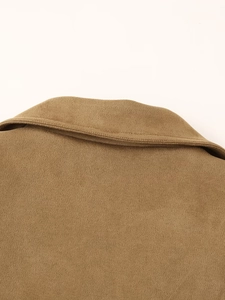 Detail shot of a brown faux suede blazer collar showing fine stitching and matte texture