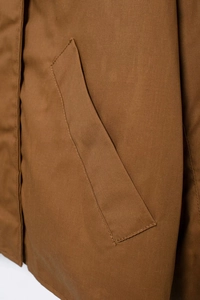 Close-up of caramel brown canvas jacket showing durable fabric texture and double stitching