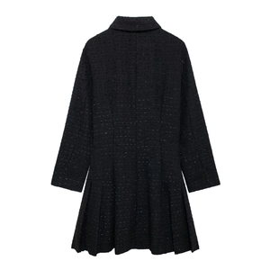 Détail de la robe en tweed noir à manches longues avec ourlet plissé et col sophistiqué