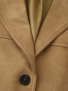 Detail of camel suede blazer featuring notched lapels and premium button stitching