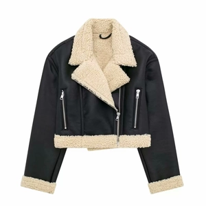 Detail shot of black biker jacket featuring cream faux shearling collar and zipper pockets