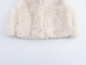 Close-up of fluffy faux fur texture in apricot beige showing soft plush material details
