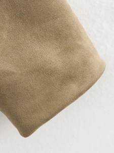Detailed macro shot showing the soft khaki suede fabric texture and brushed finish