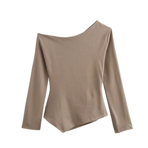 Detail of tan off-shoulder long sleeve top with asymmetric hem and ruched fabric texture