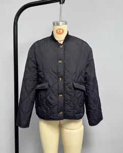 Macro view of diamond-quilted jacket detailing stand collar and functional flap pockets
