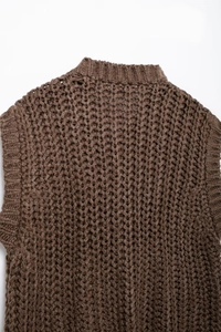 Detail of the chunky knit texture and back neckline on a dark brown sweater vest