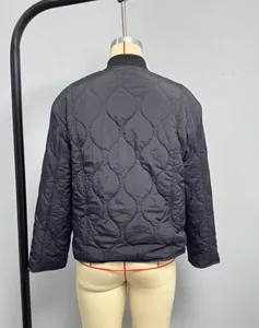 Detail of black wave-quilted jacket featuring a ribbed collar and glossy fabric back