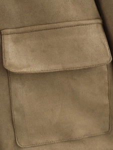 Detailed macro view of camel suede jacket fabric texture and flap pocket stitching