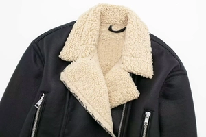 Detail of faux shearling collar and silver metal zippers on black leather moto jacket
