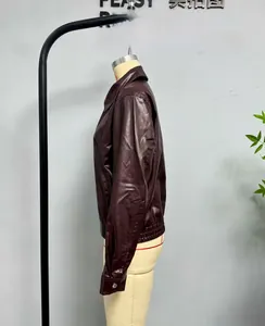 Side view of dark burgundy faux leather jacket featuring classic lapels and metal cuffs