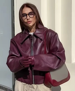 Macro shot of stylish burgundy oversized faux leather jacket with metallic zipper detail