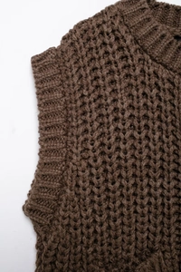 Close-up of deep brown chunky knit vest showing honeycomb texture and ribbed neckline
