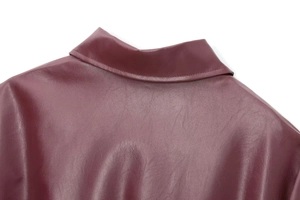 Close-up of lapel stitching and premium burgundy faux leather texture on jacket