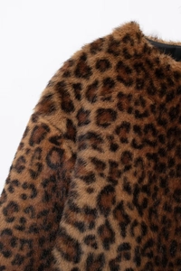 Macro texture of premium leopard print faux fur coat with smooth black silk lining