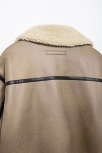 Détail de la veste aviateur en daim kaki avec col en peau de mouton blanche et liseré cuir